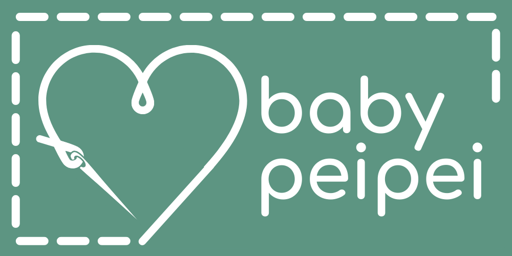 A rectangular patch with stitching around three-quarters of its perimeter. The needle and thread have formed a heart. The text phonetically reads "baby pay pay".