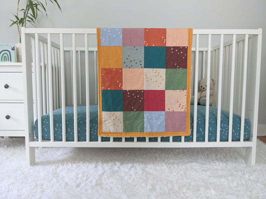 Baby Peipei 's organic patchwork quilt with pastel and earth tones. This quilt is security blankie sized. With 12 fabrics, this quilt is reminiscent of the Bai Jia Bei Chinese quilt tradition