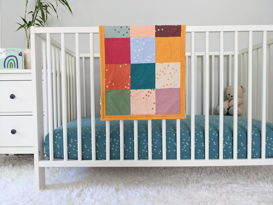 Baby Peipei 's organic patchwork quilt with pastel and earth tones. This quilt is lovey sized. With 12 fabrics, this quilt is reminiscent of the Bai Jia Bei Chinese quilt tradition
