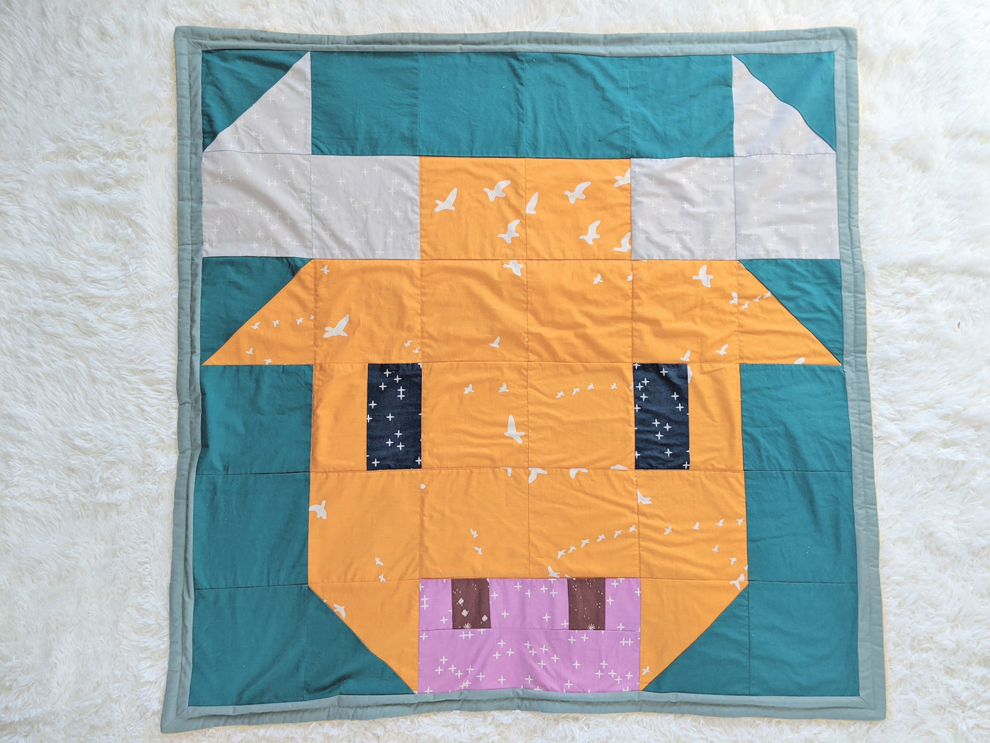 Baby Peipei- 2021: Year of the Ox, backed with Butter Furry Sherpa. An ox quilt pattern made up of square, triangle, and rectangular patches.