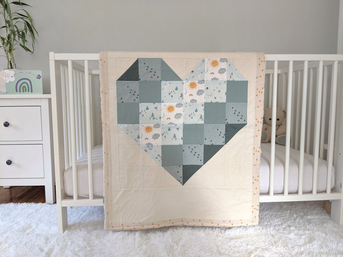 Ombre Heart with Sage, backed with Fluffy Sherpa. Hanging over the side of a crib in a nursery.