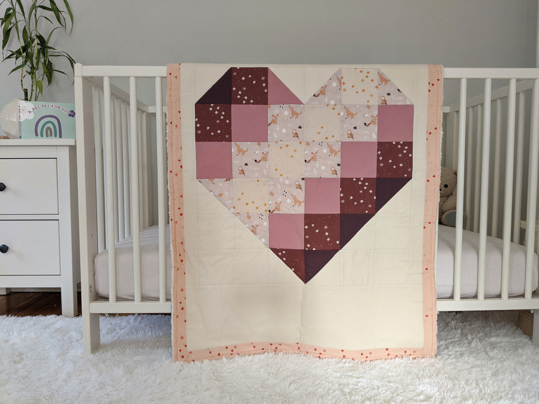 Ombre Heart with Wood Rose, backed with Fluffy Sherpa. Hanging over the side of a crib in a nursery.