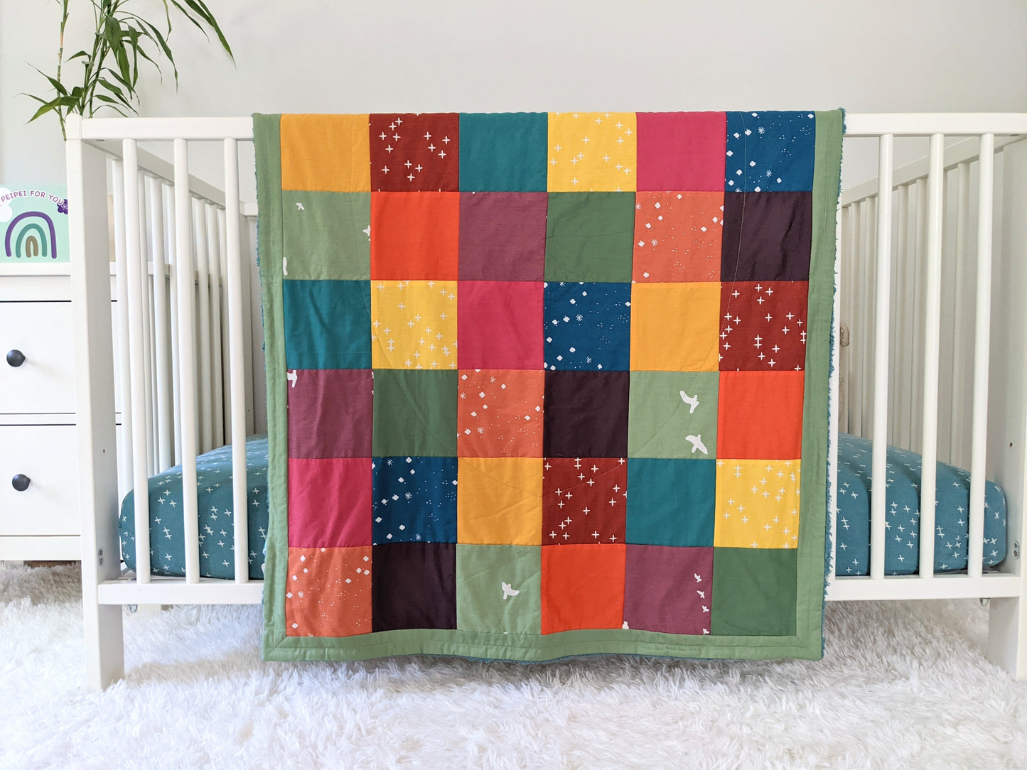 Baby Peipei's organic patchwork quilts with bright colors. This patchwork quilt is crib size. With 12 fabrics, this quilt is reminiscent of the Bai Jia Bei Chinese quilt tradition 