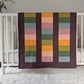 Boho Rainbow on Huckleberry, Original size, backed with Fluffy Sherpa hanging over a crib side