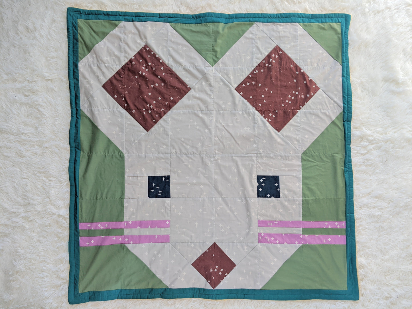 Baby Peipei- 2020: Year of the Rat or Mouse, backed with Butter Furry Sherpa. A quilt mouse pattern made up of square, triangle, and rectangular patches.